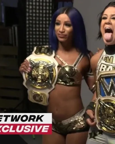 WWE – Sasha Banks and Bayley posing with the Tag Team titles